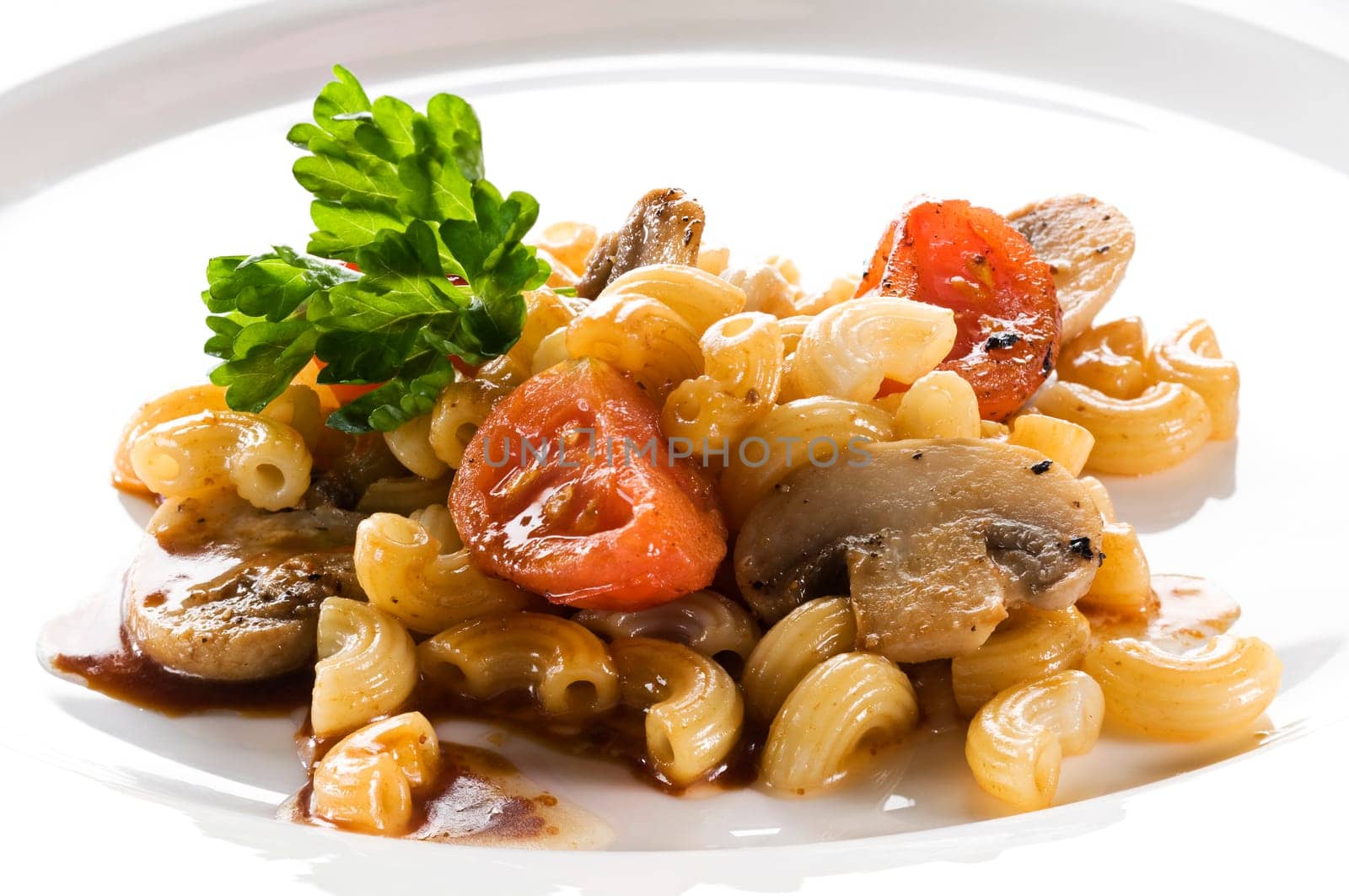 Macaroni pasta with tomato and mushrooms close up