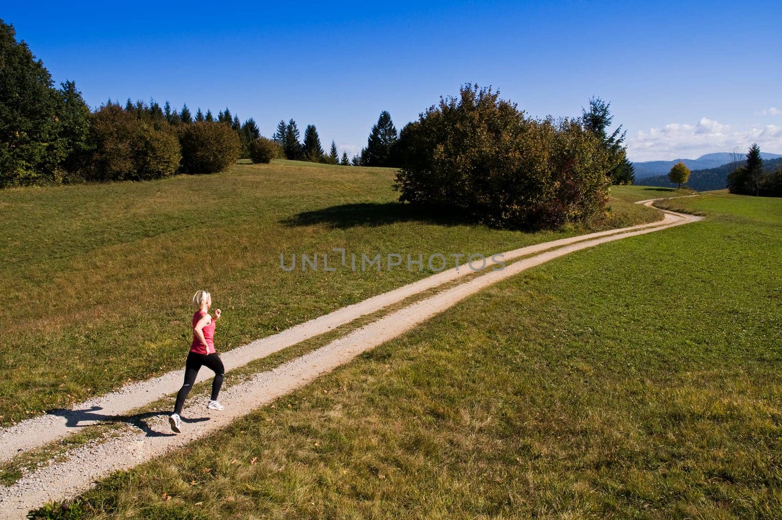 Young woman running outdoor in autumn time