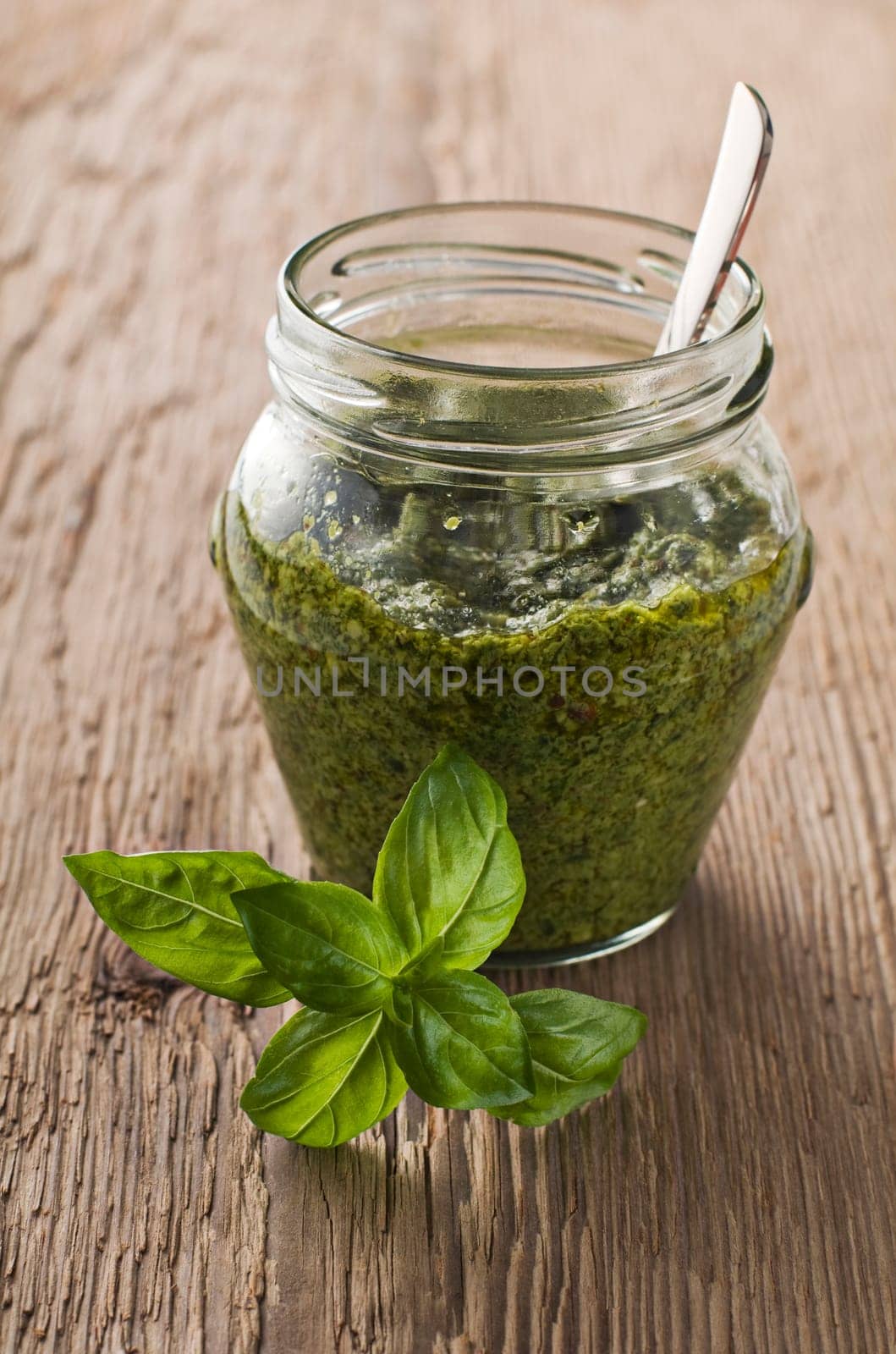 Fresh basil pesto in a jar close up