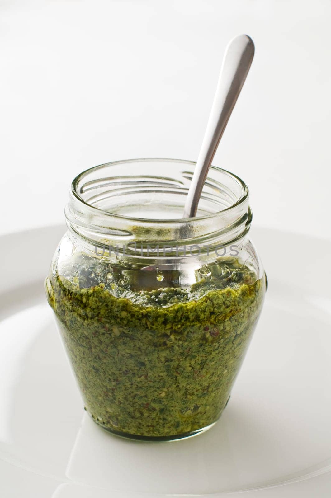 Fresh italian basil pesto in a jar close up