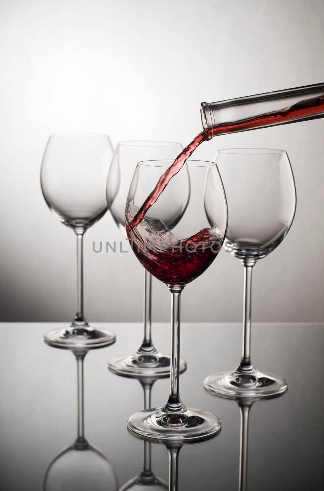 Red wine pouring into glass close up