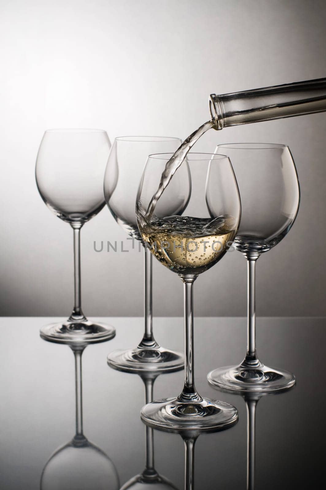 White wine pouring into glass close up
