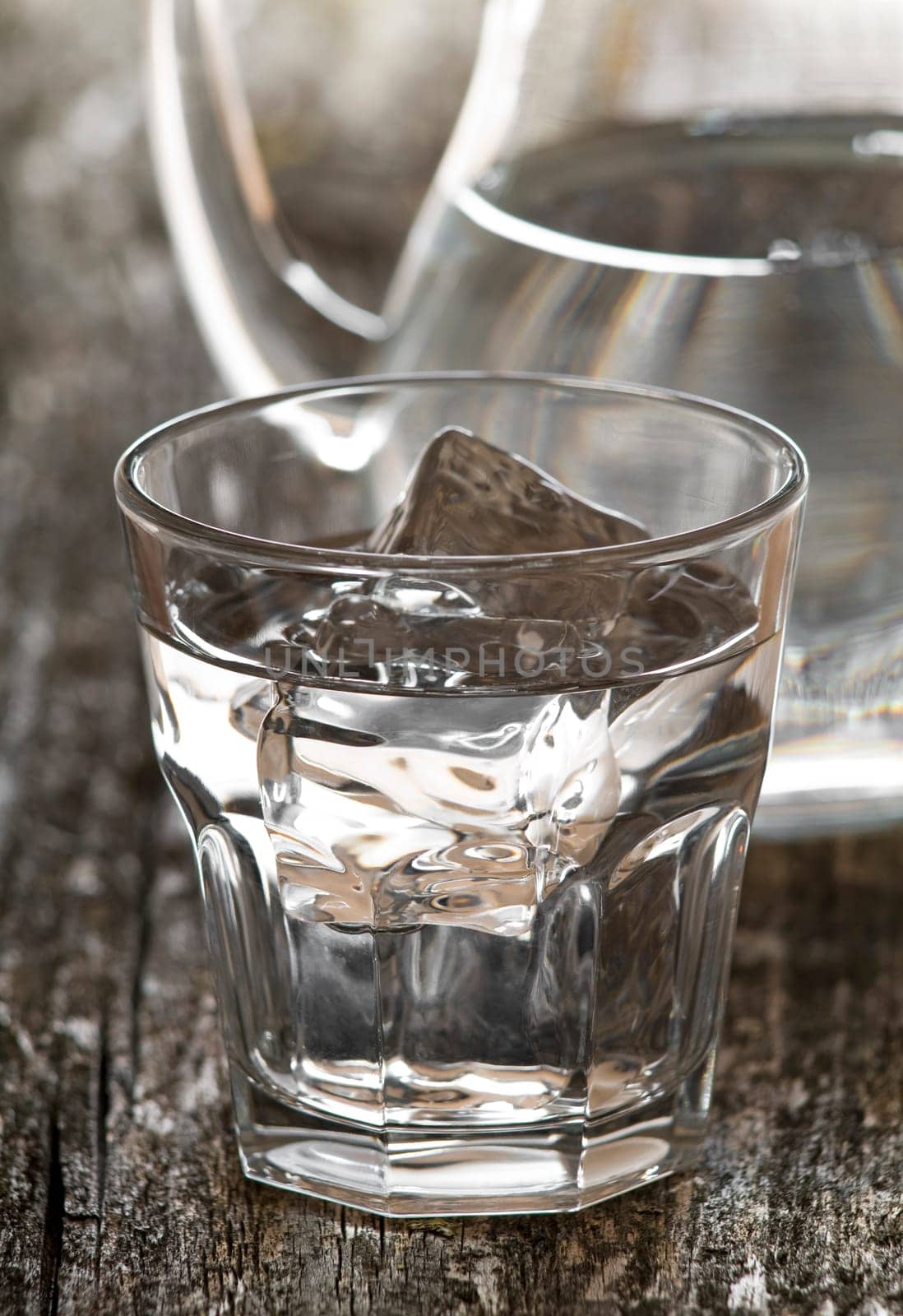 fresh water in glass with ice close up