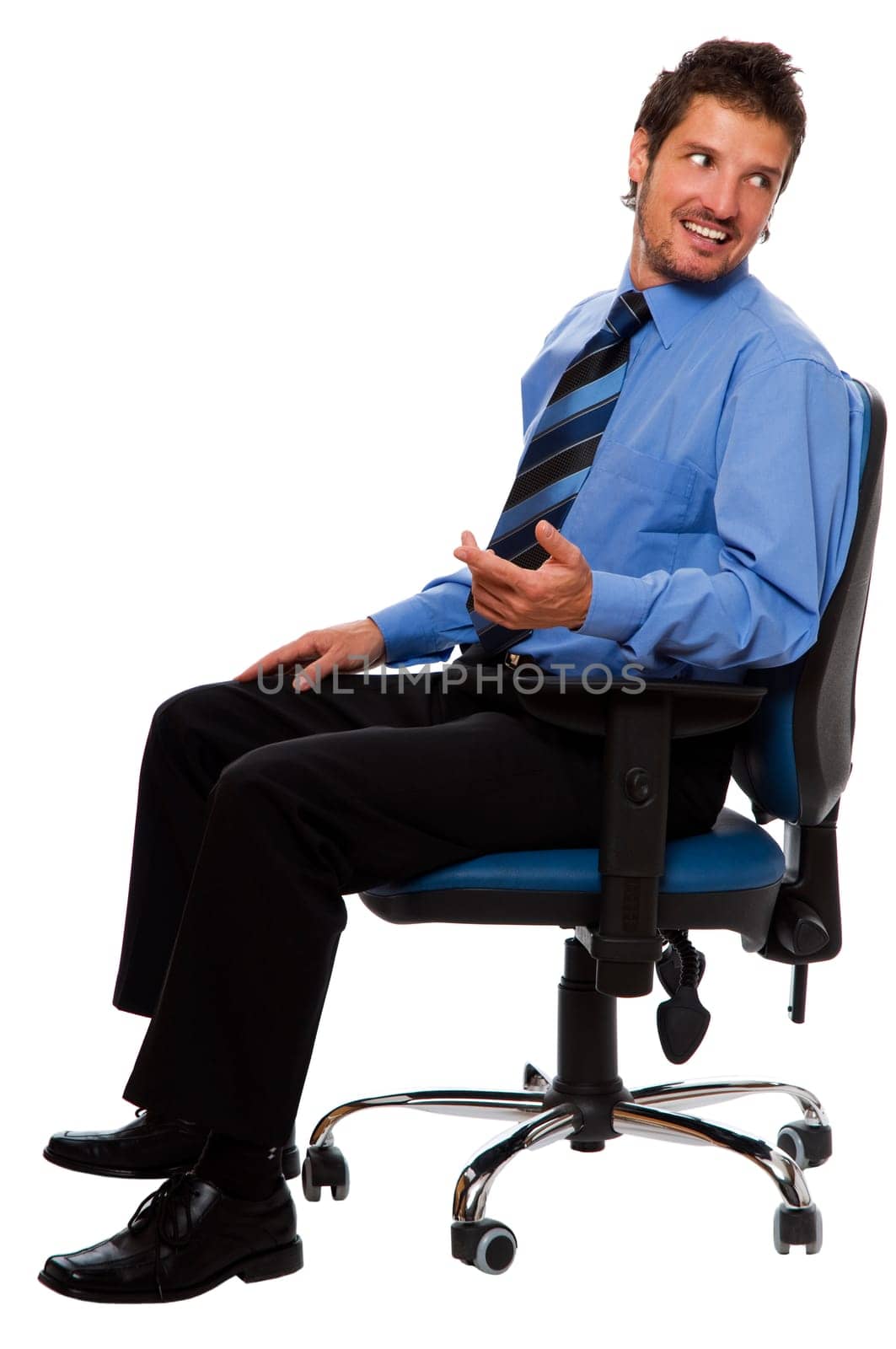 young business man sitting in a chair looking back