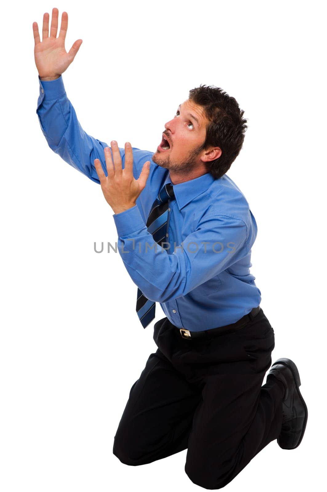 young business man on his knees looking up