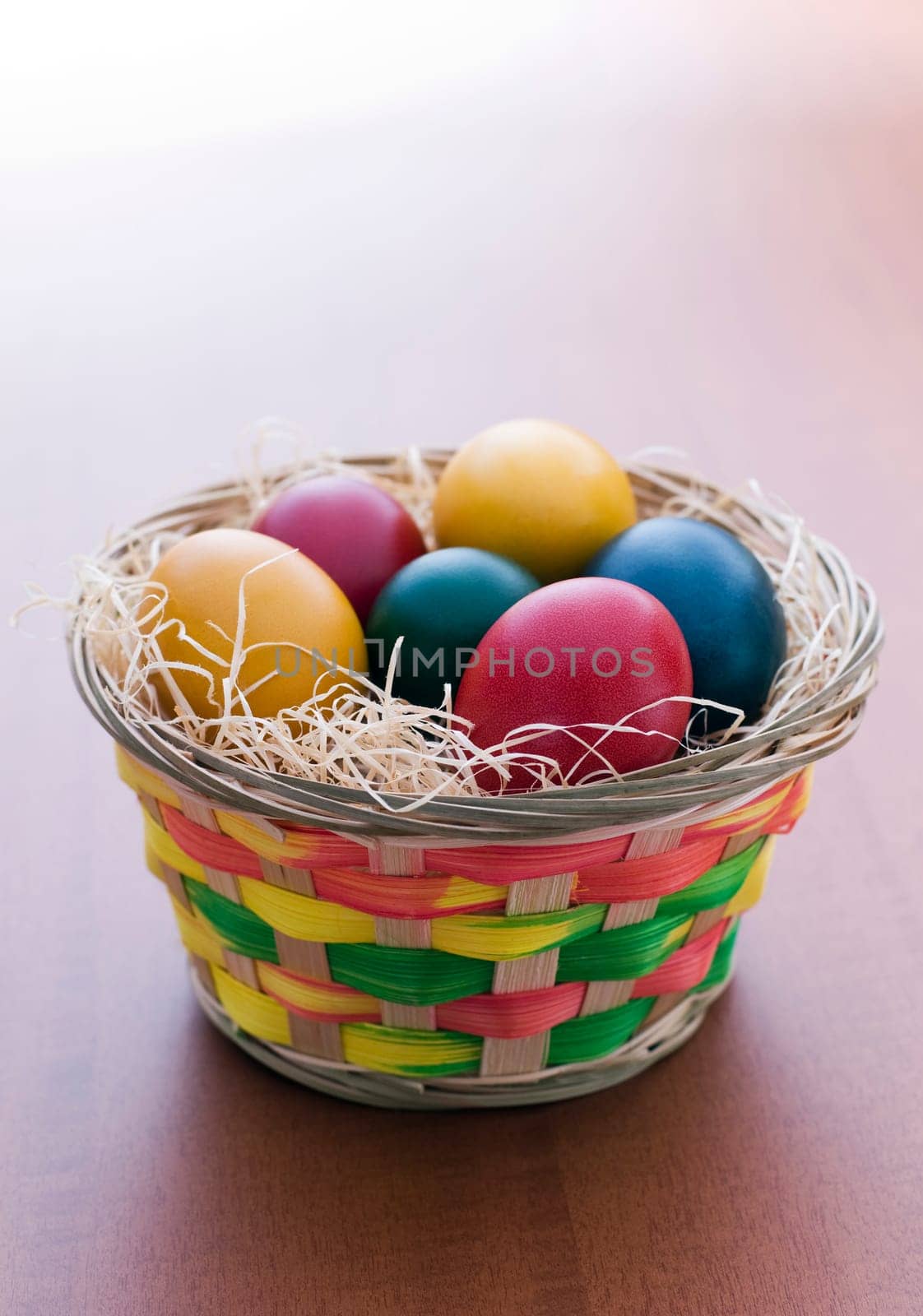 Colorful easter eggs in a basket close up