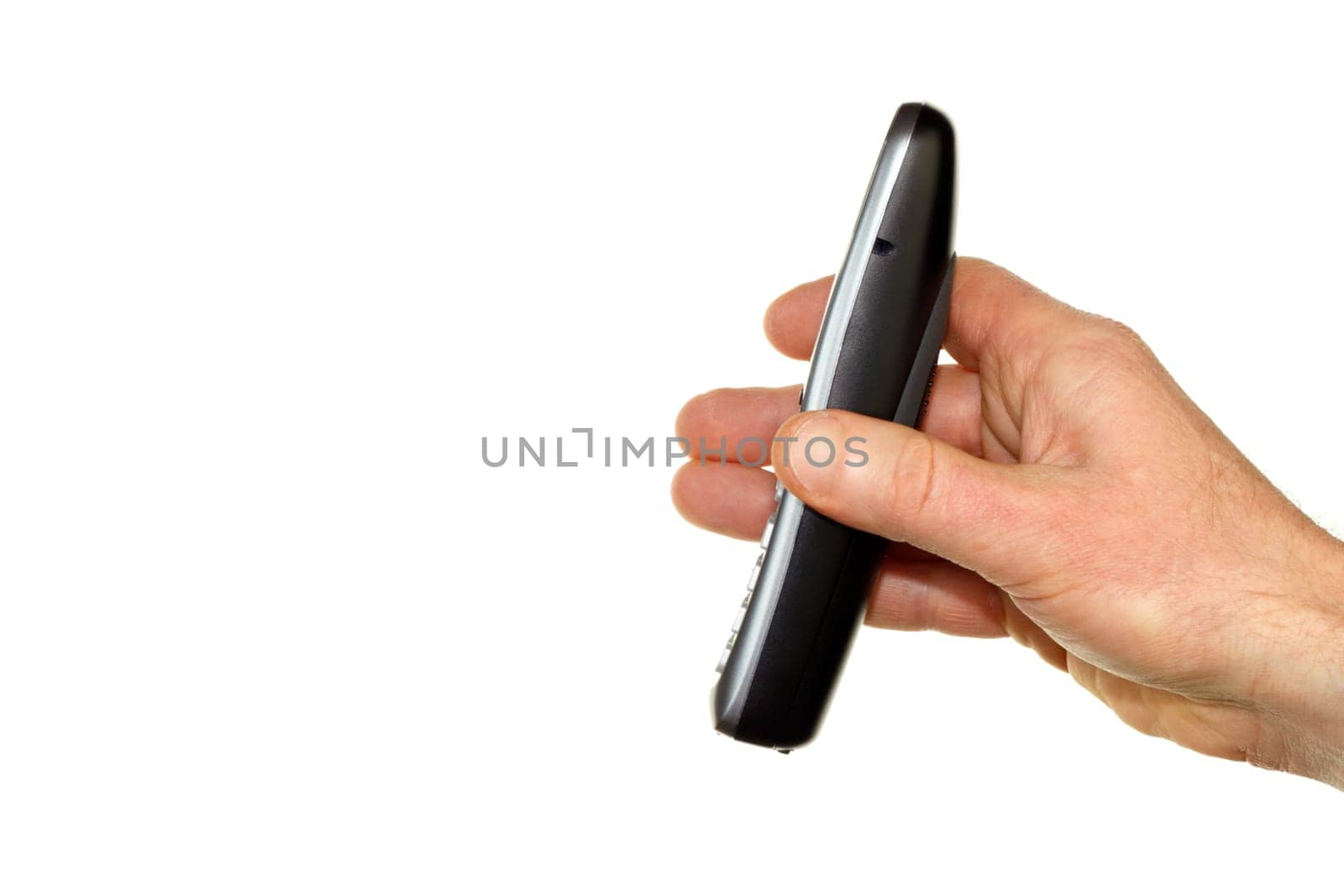 Caucasian male adult hand with cordless telephone handset raised up on the right in front of a white background.