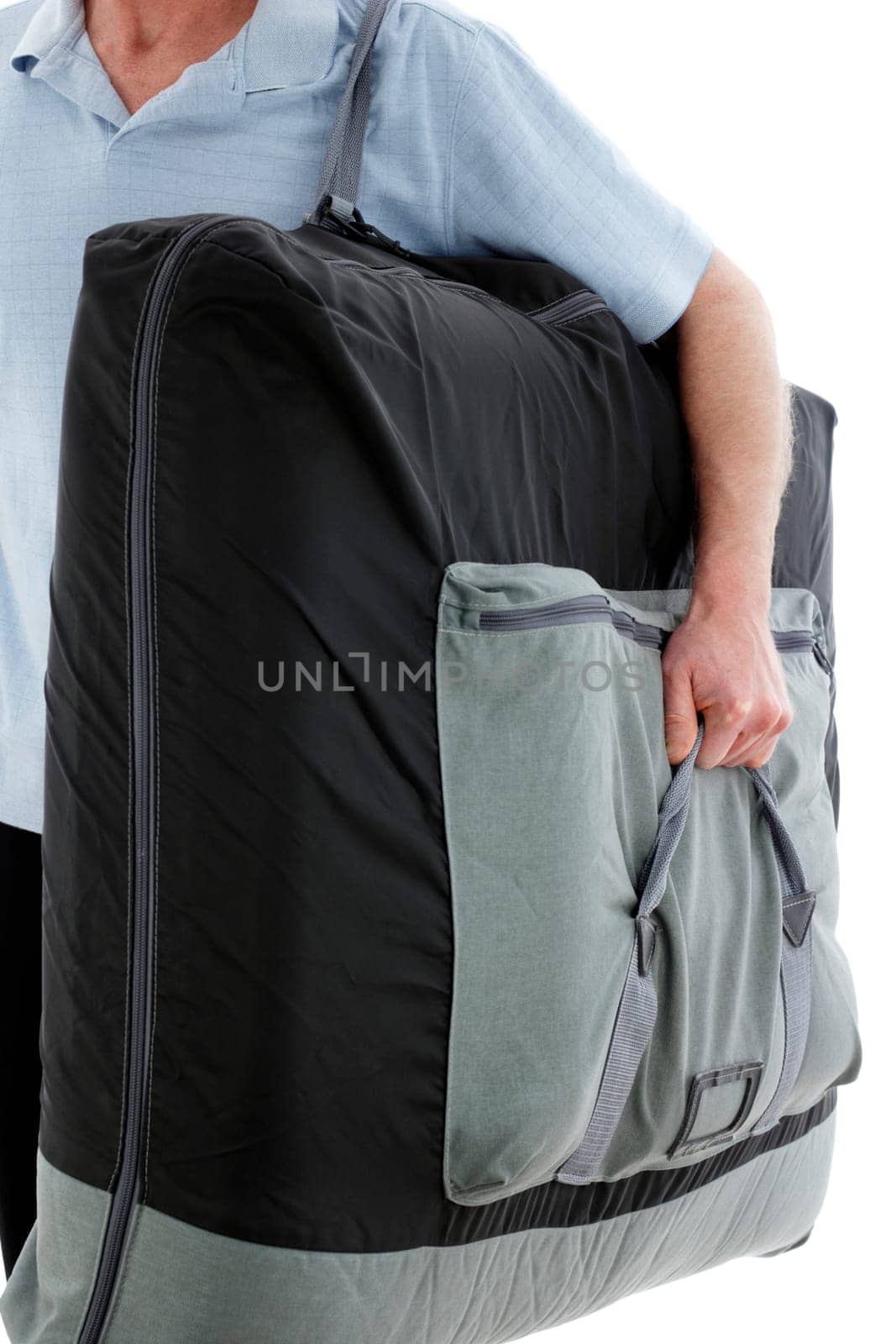 Professional licensed massage therapist man carrying a portable massage table on his way to do a outcall massage therapy for a client at his home.