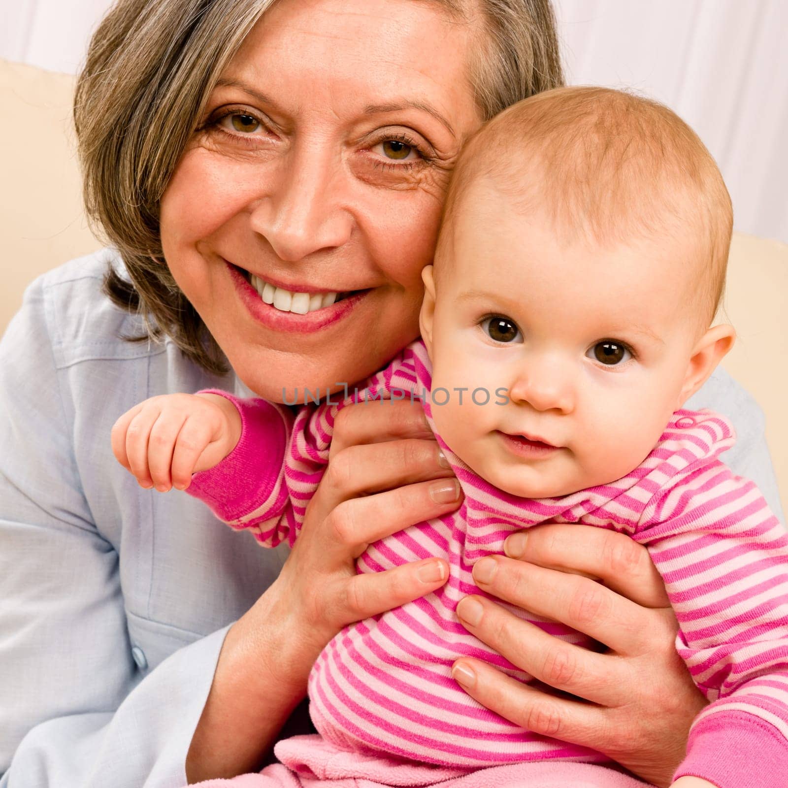 Senior woman hold little baby girl cute smiling close-up