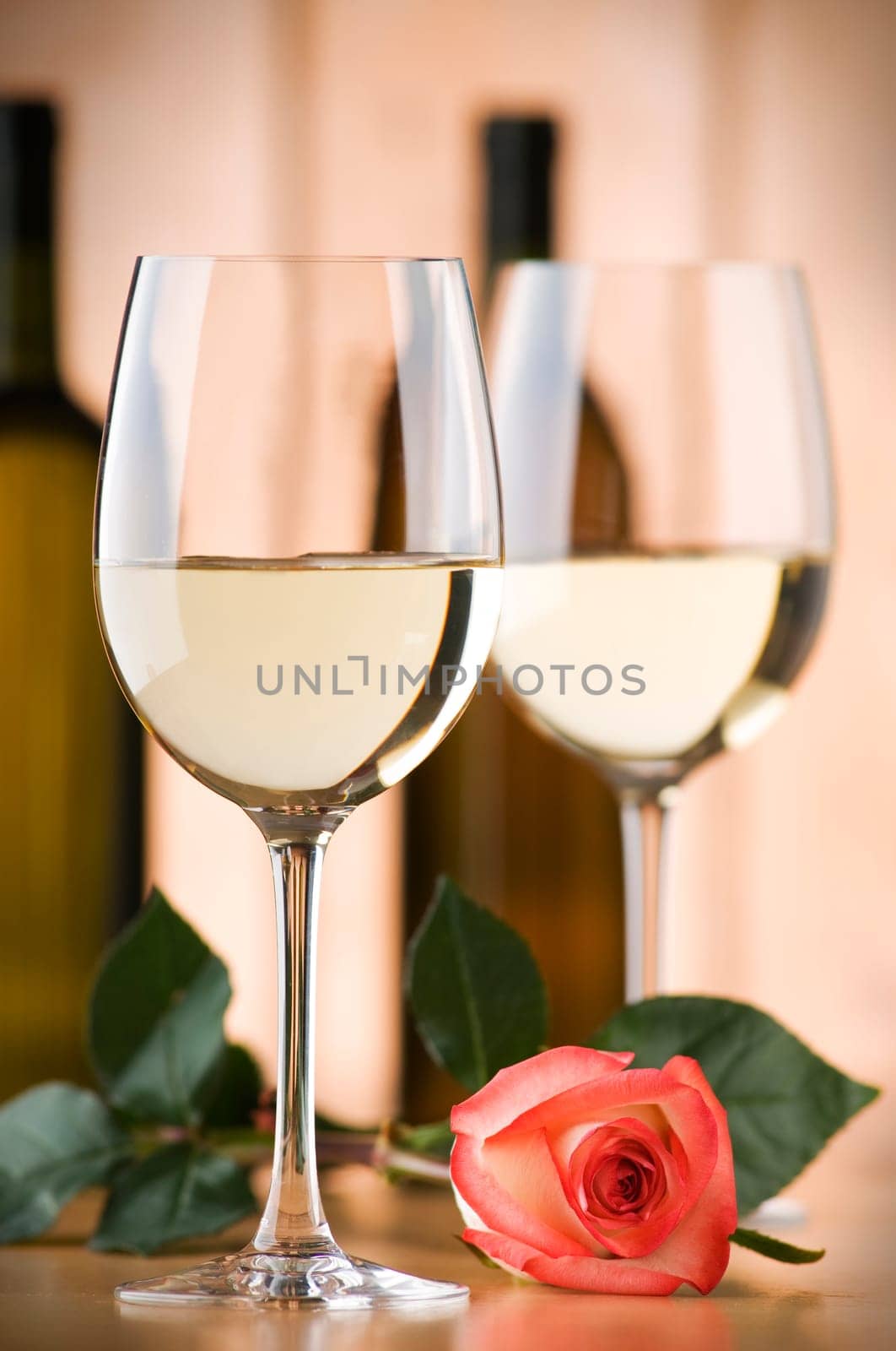 glass of white wine with rose close up shoot