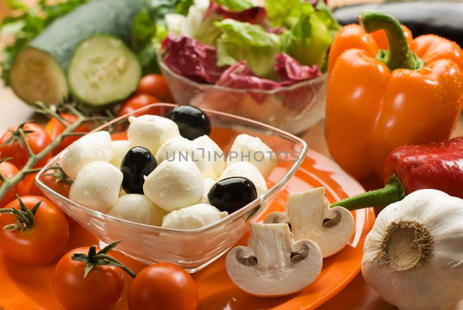 fresh mozzarella cheese in a bowl with vegetables close up
