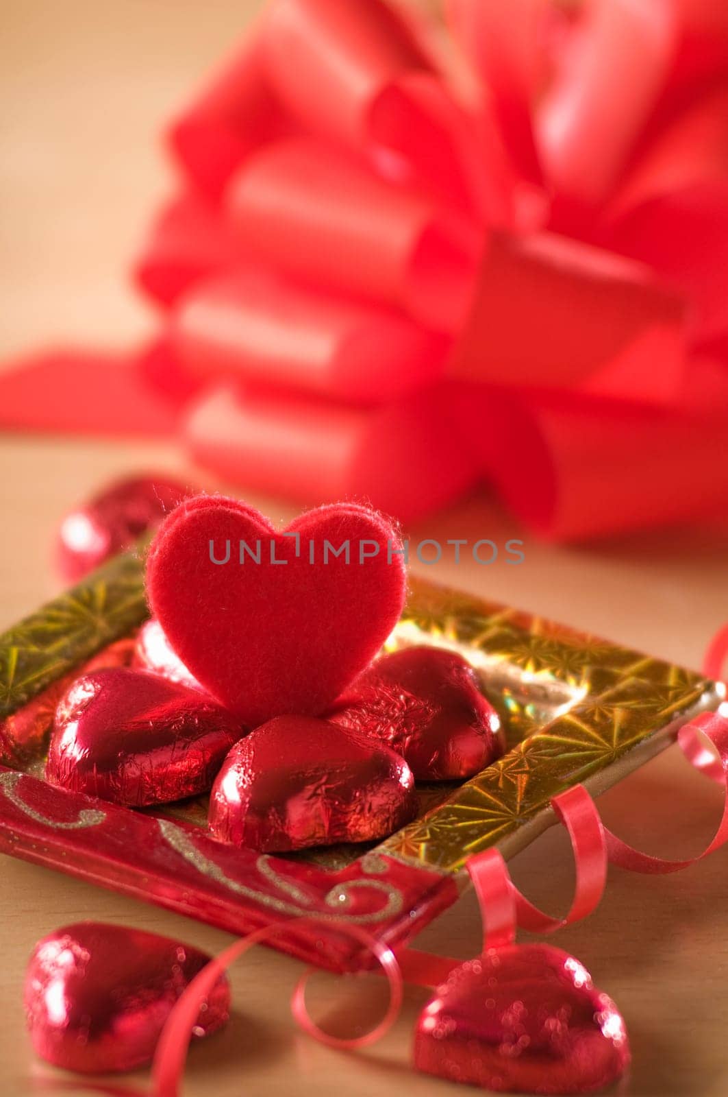 heart shaped candy on a golden plate close up