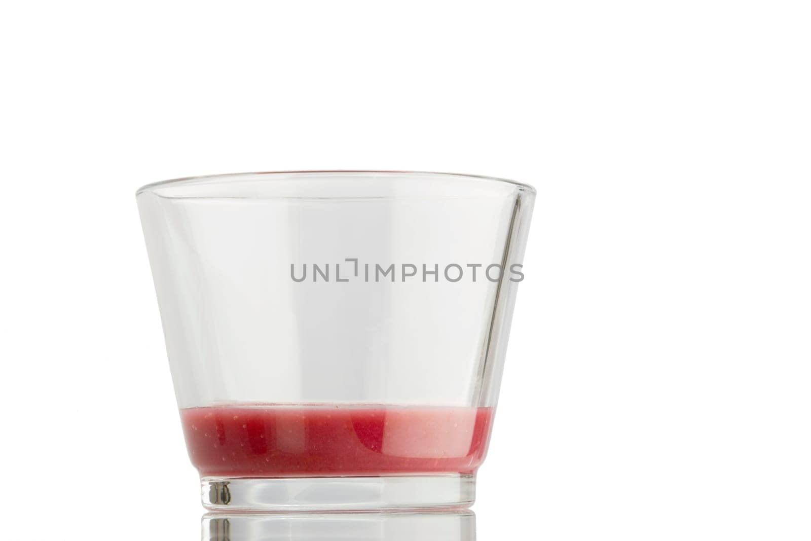 An almost empty glass of smoothie