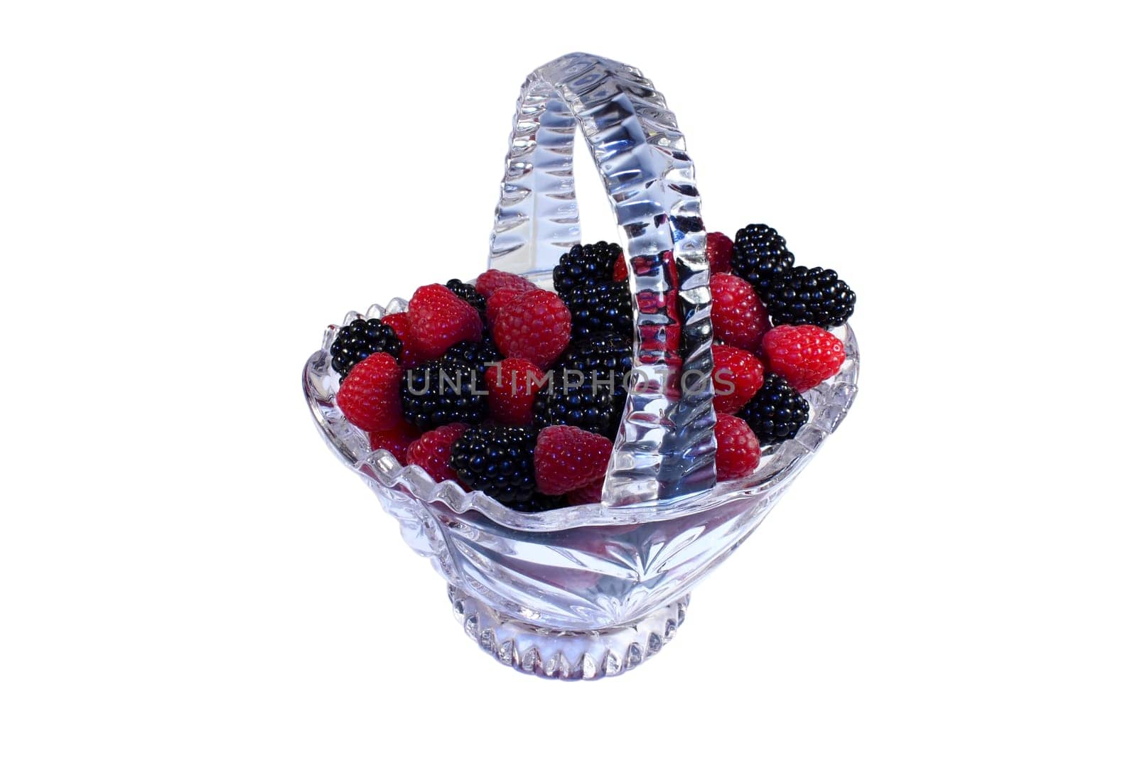 Glass basket full of fresh raspberries and blackberries