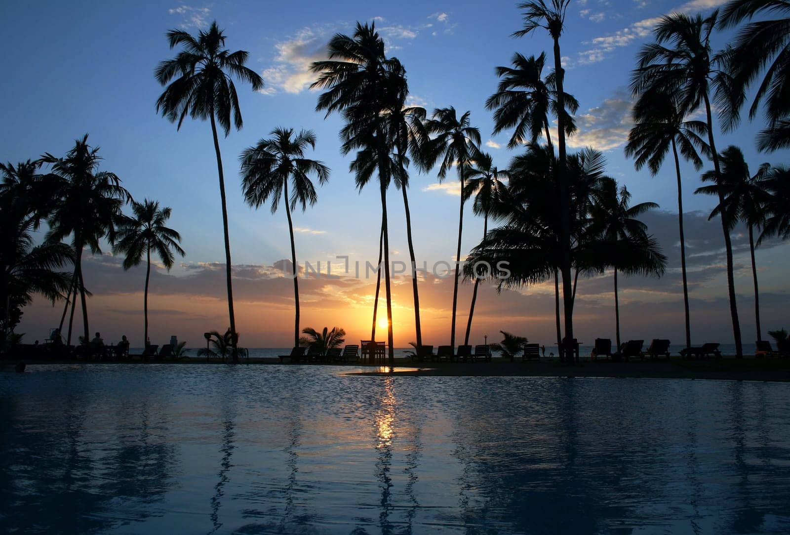 The sunset behind a swimming pool in Sri Lanka
