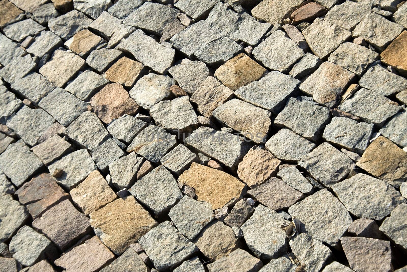 Diagonal pattern of layered, unevenly dressed, stone wall