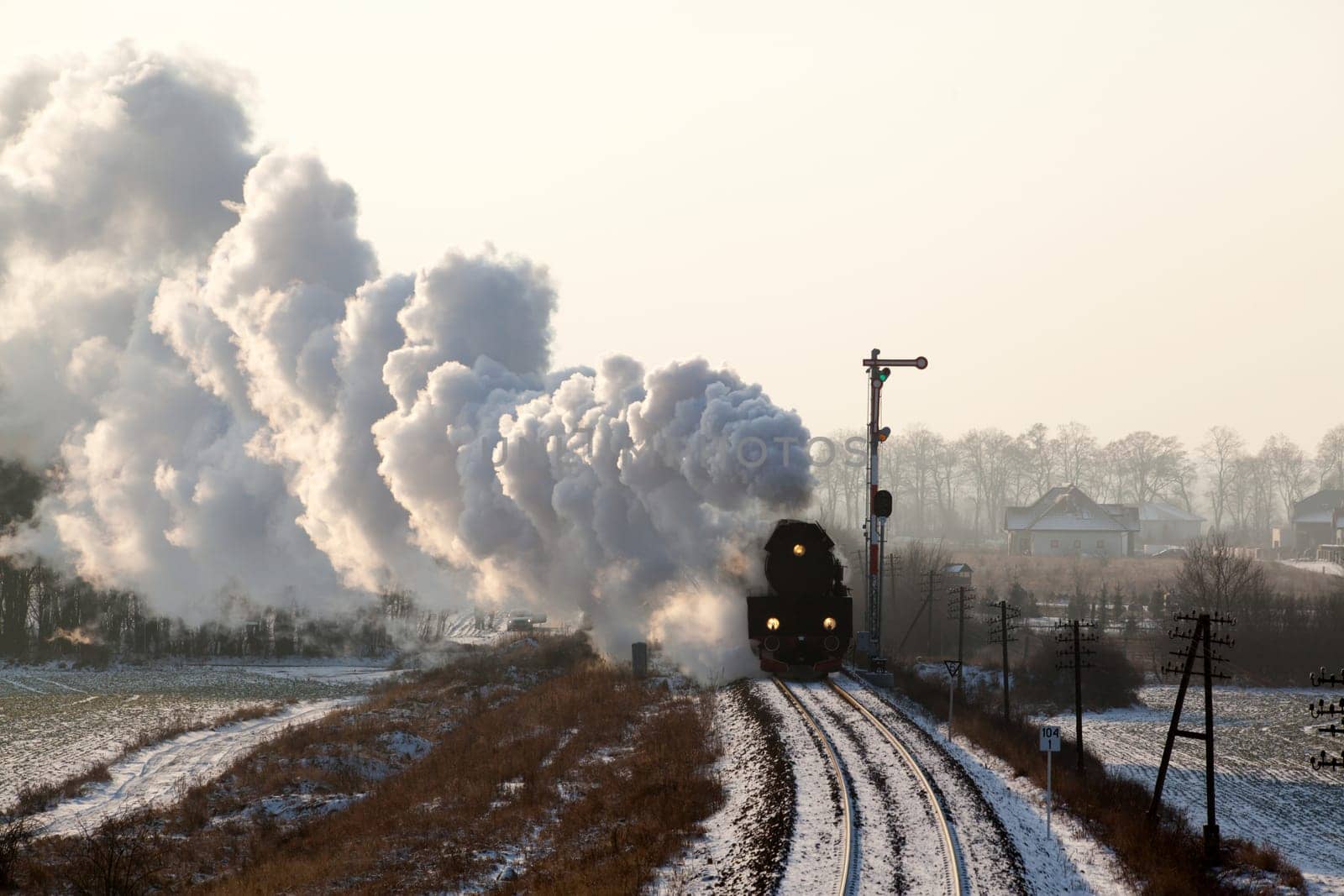 Vintage steam train starting from the station, wintertime