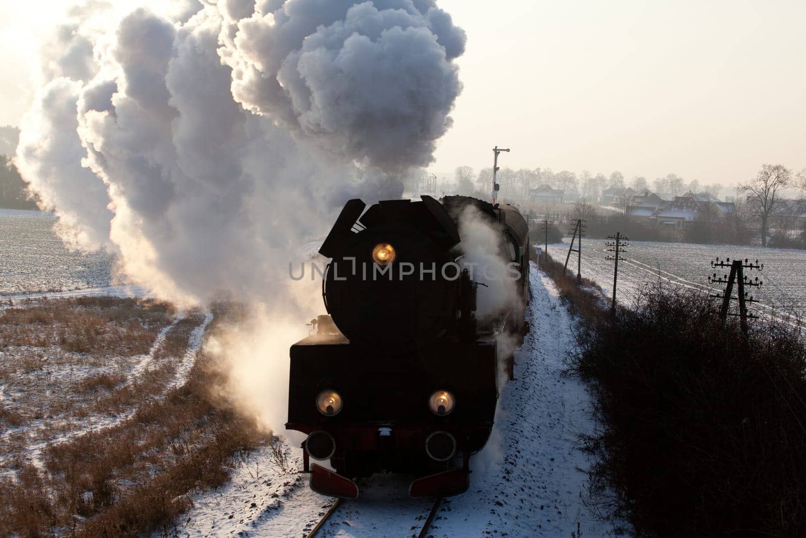 Vintage steam train starting from the station, wintertime