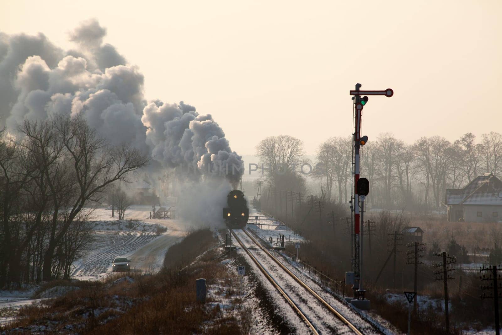 Vintage steam train starting from the station, wintertime