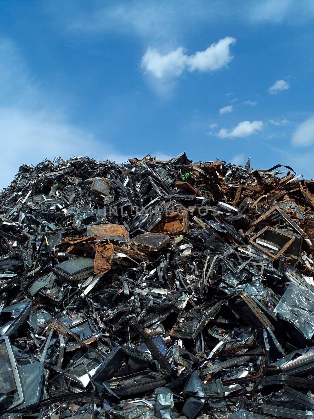 Stack of Metal Garbage in front of blue sky
