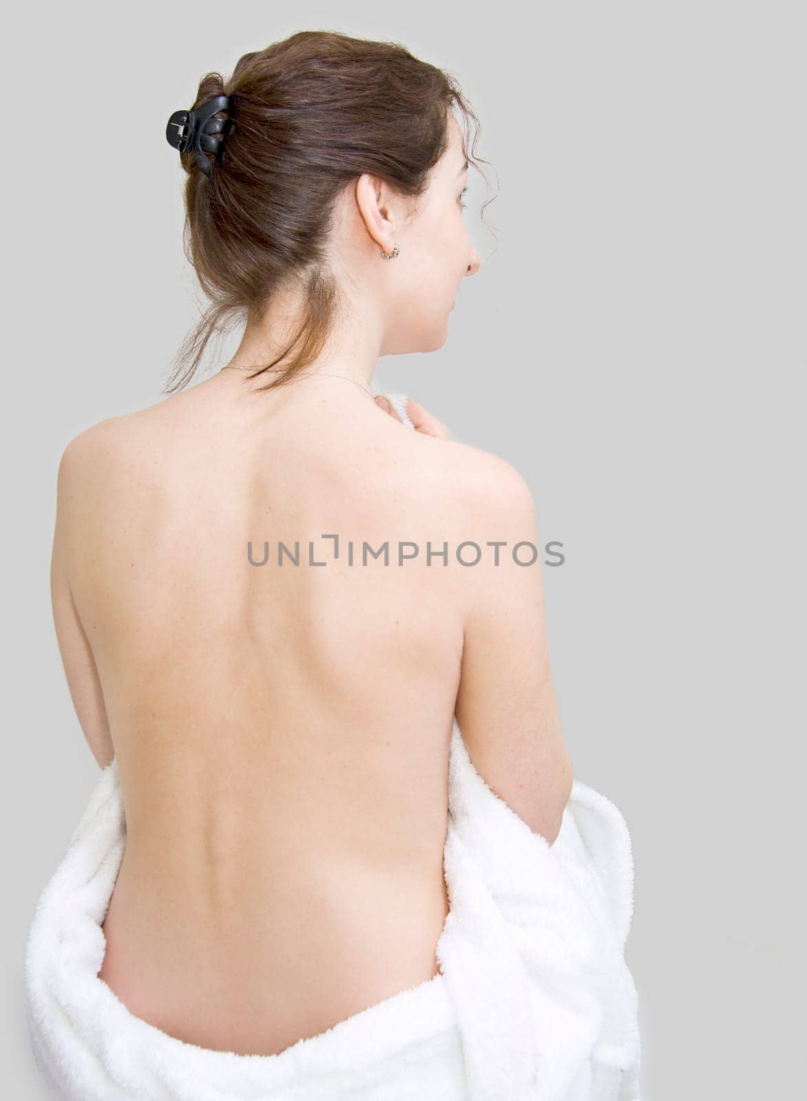 Back of a young beautiful woman. Isolated on gray background