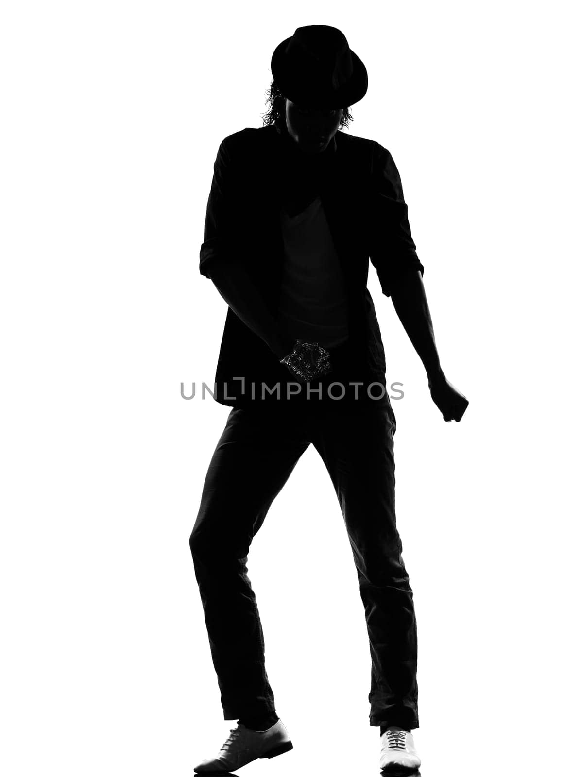 full length silhouette of a young man dancer dancing funky hip hop r&amp b on  isolated  studio white background