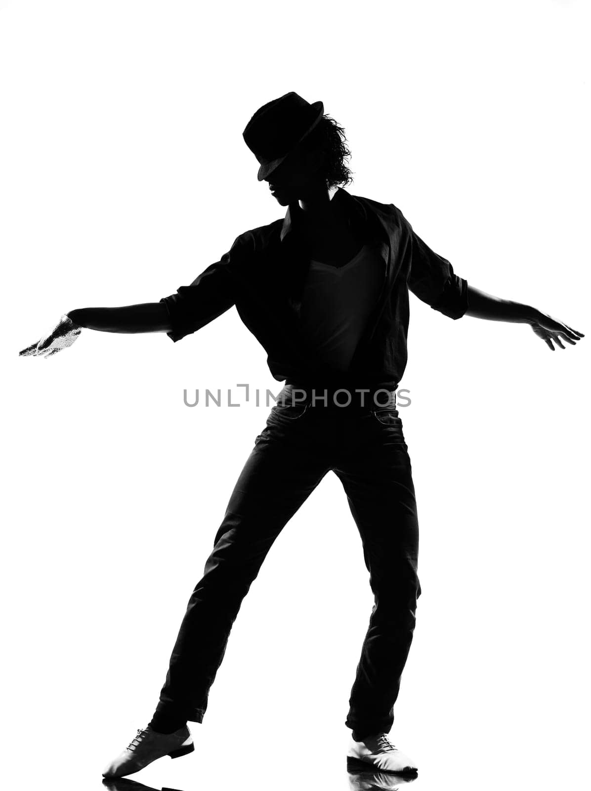 full length silhouette of a young man dancer dancing funky hip hop r&amp b on  isolated  studio white background