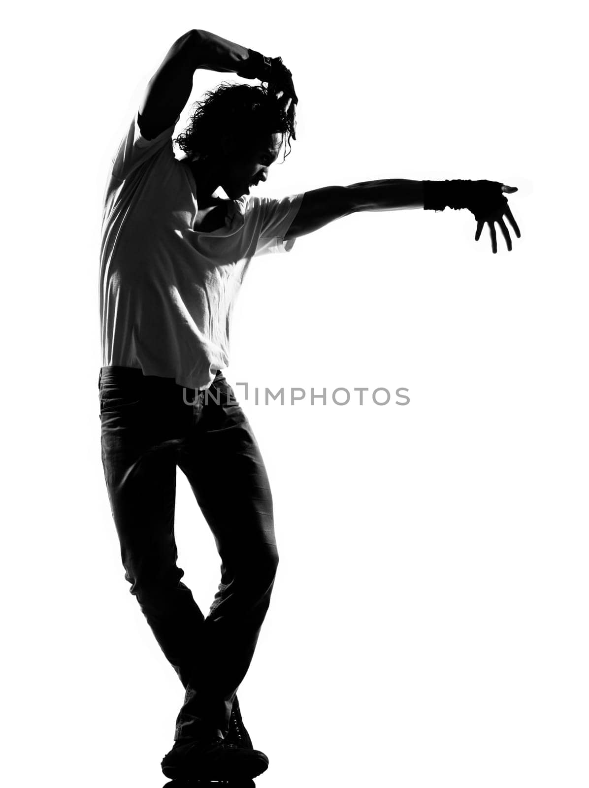 full length silhouette of a young man dancer dancing funky hip hop r&amp b on  isolated  studio white background
