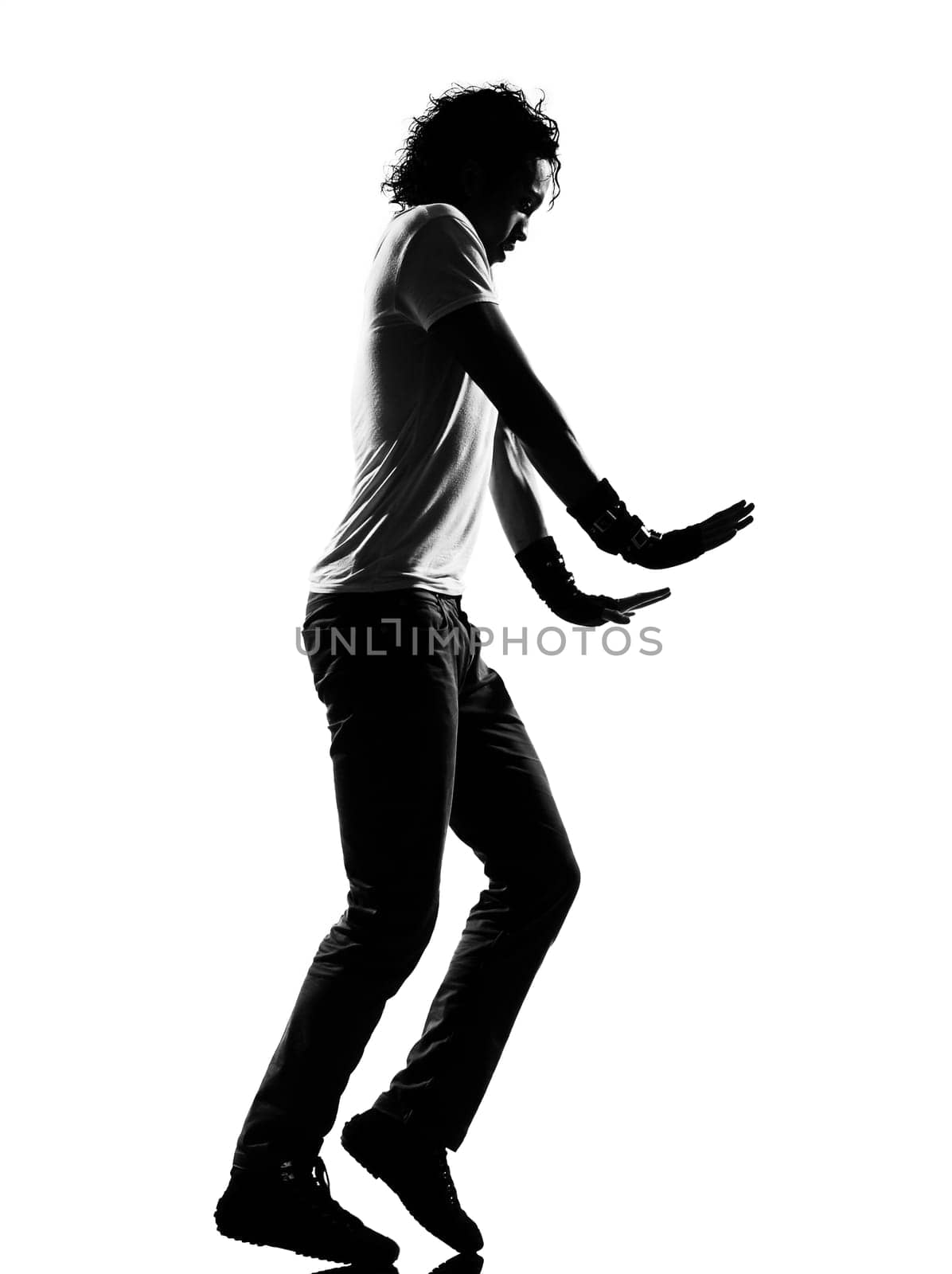 full length silhouette of a young man dancer moonwalk dancing funky hip hop r&amp b on  isolated  studio white background