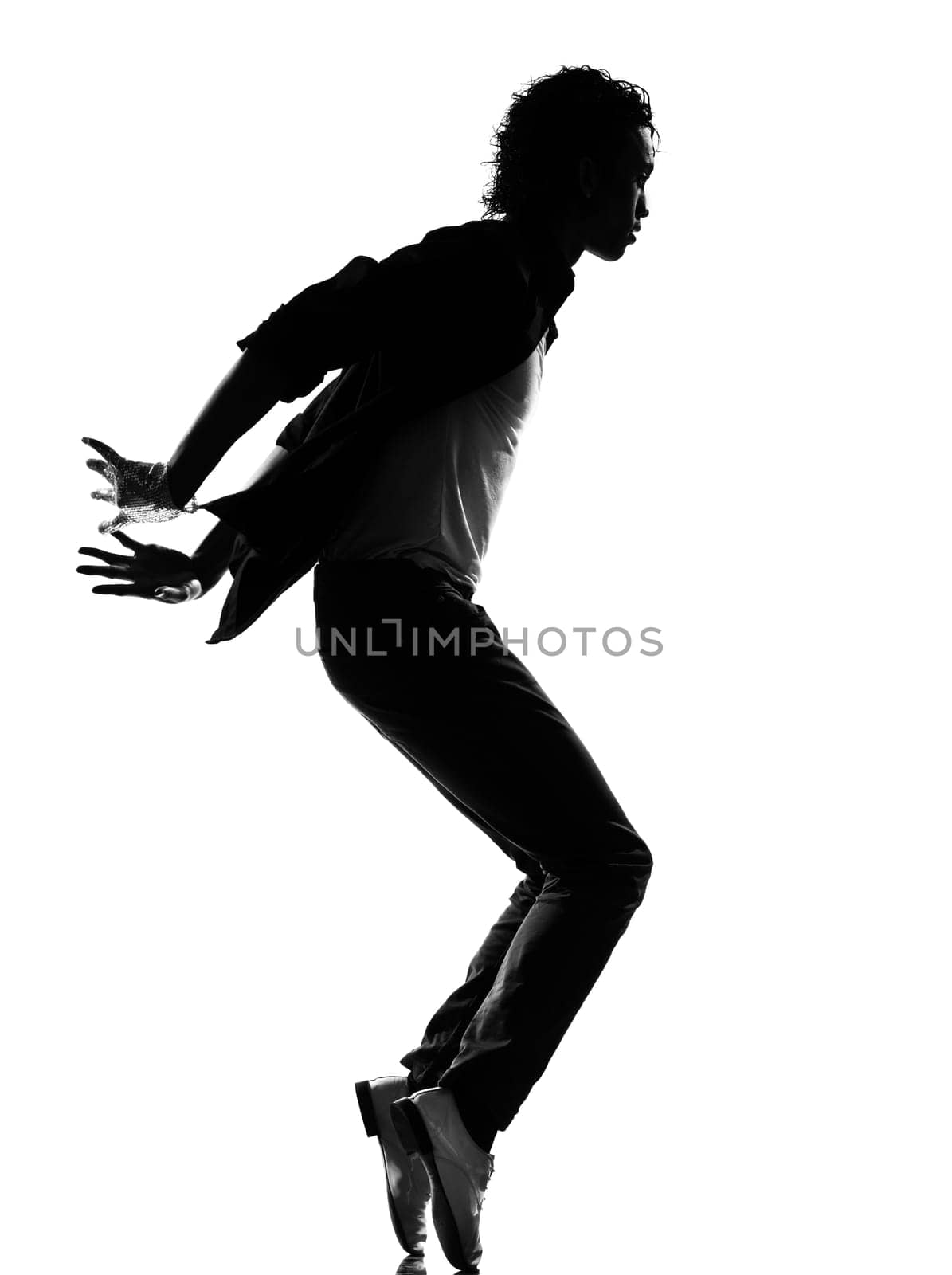 full length silhouette of a young man dancer dancing funky hip hop r&amp b on  isolated  studio white background