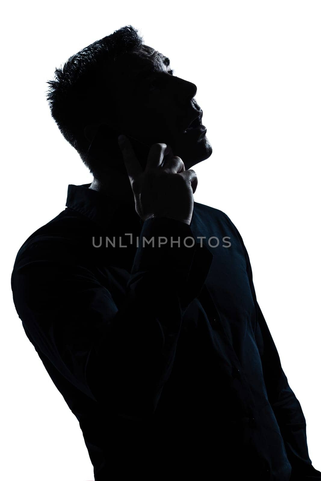 one caucasian man  telephone surprised portrait silhouette in studio isolated white background