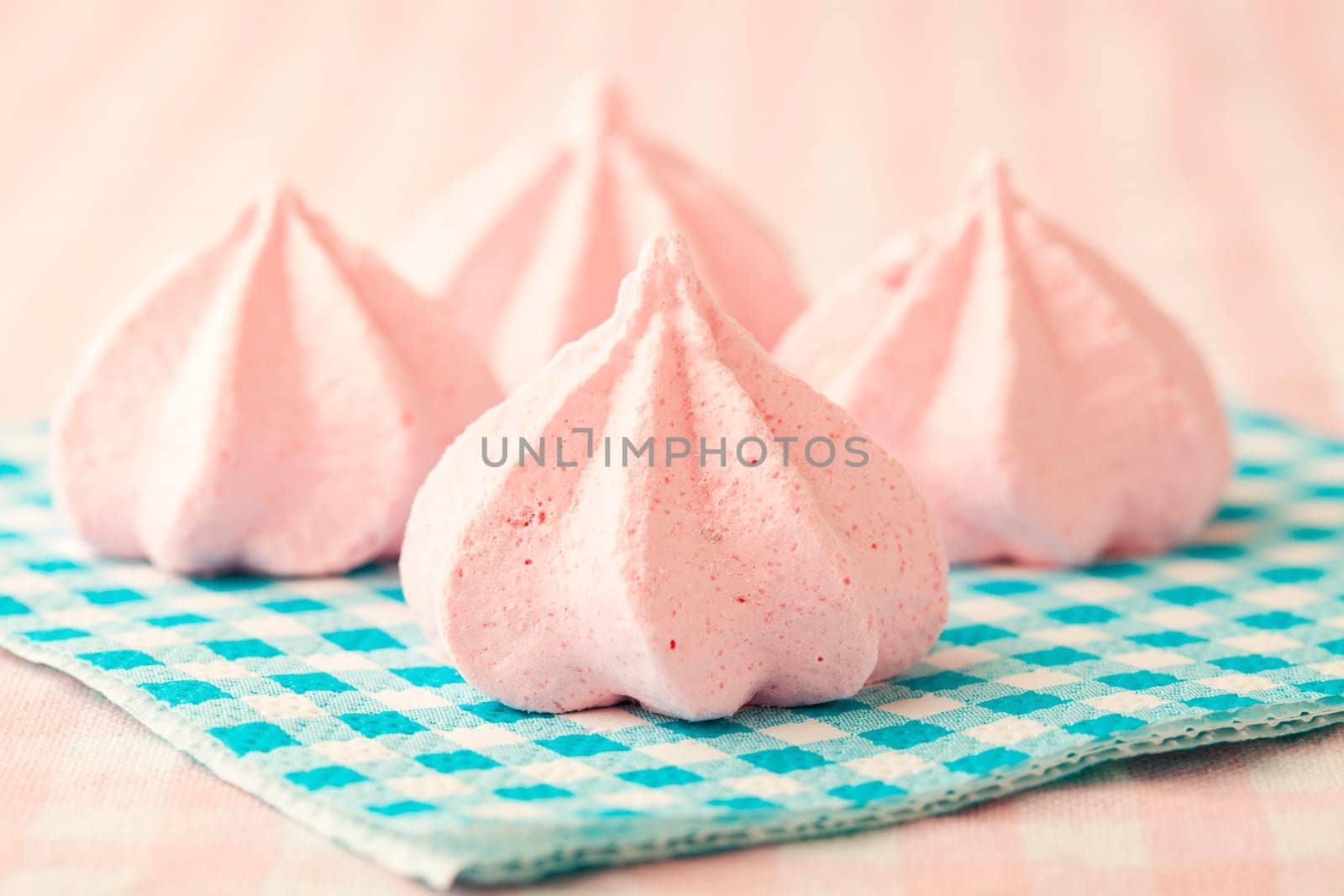 Close-up of delicious pink meringue. Studio shot.
