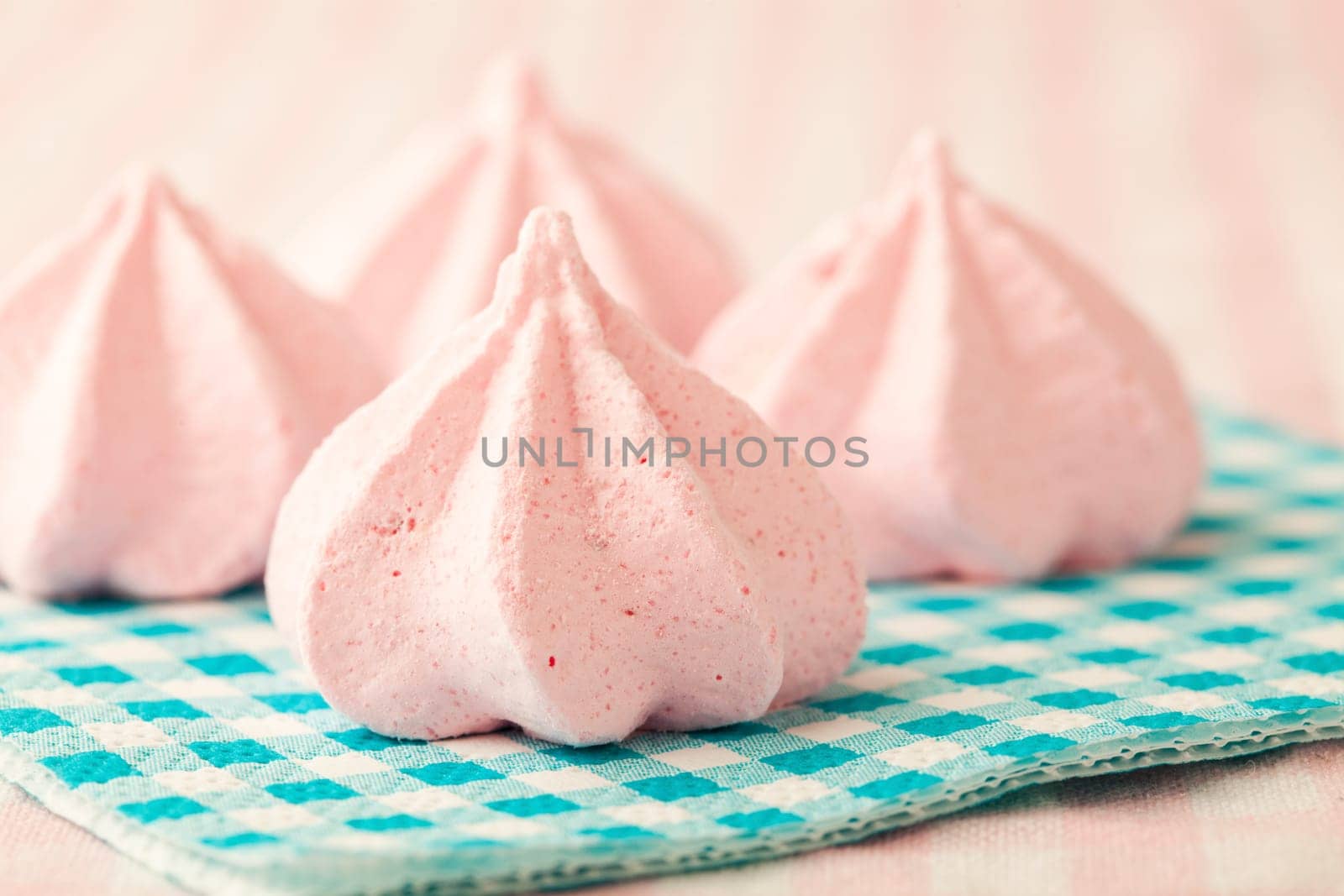 Close-up of delicious pink meringue. Studio shot.