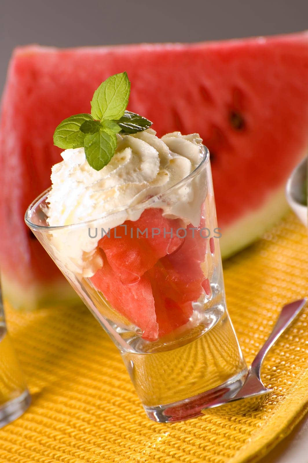 watermelon in glass with cream close up