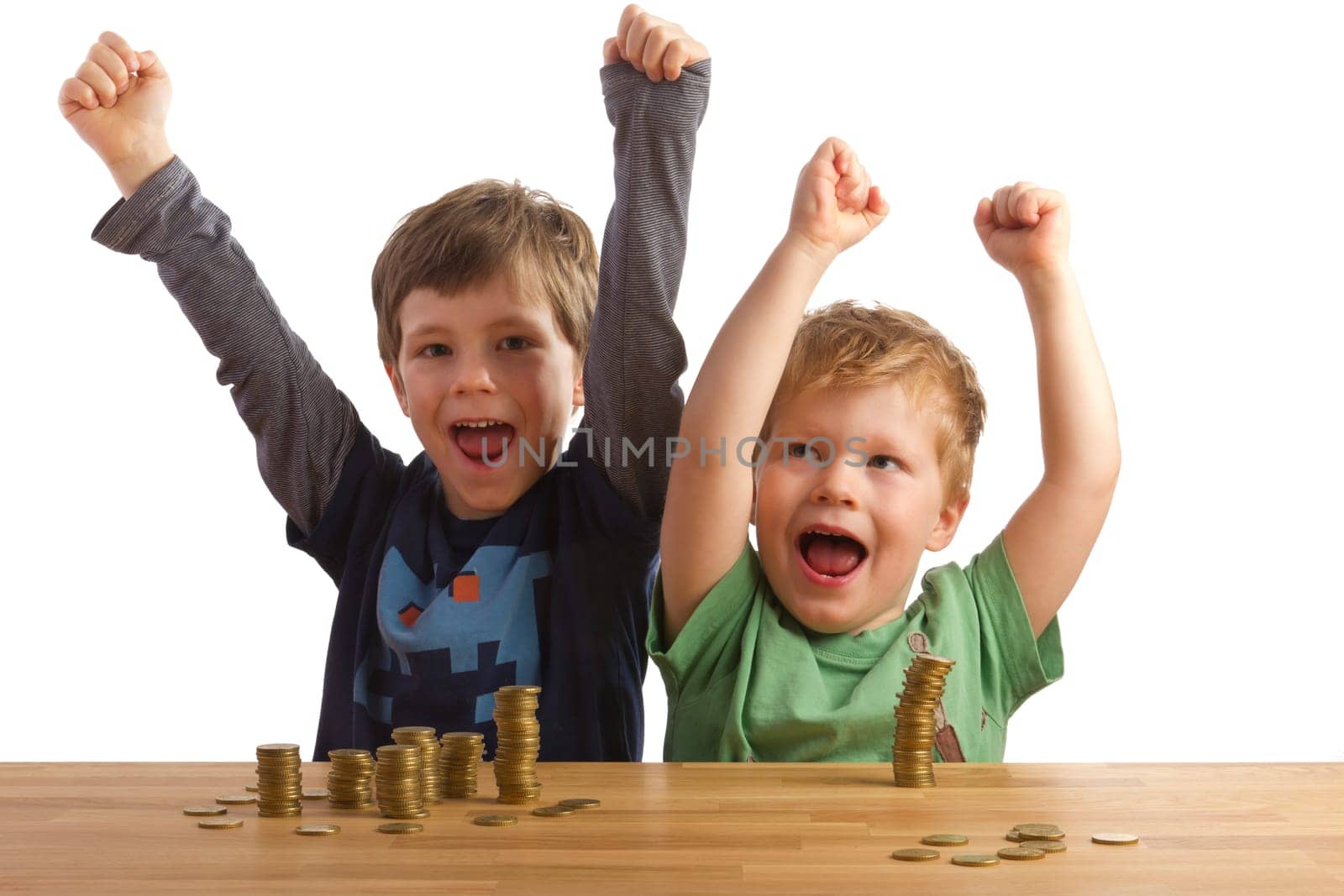 Two cheering boys sitting in front of stacks of money