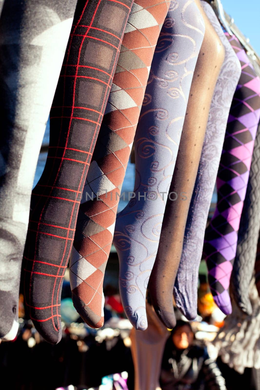colorful tights in a row hanging in an outdoor market