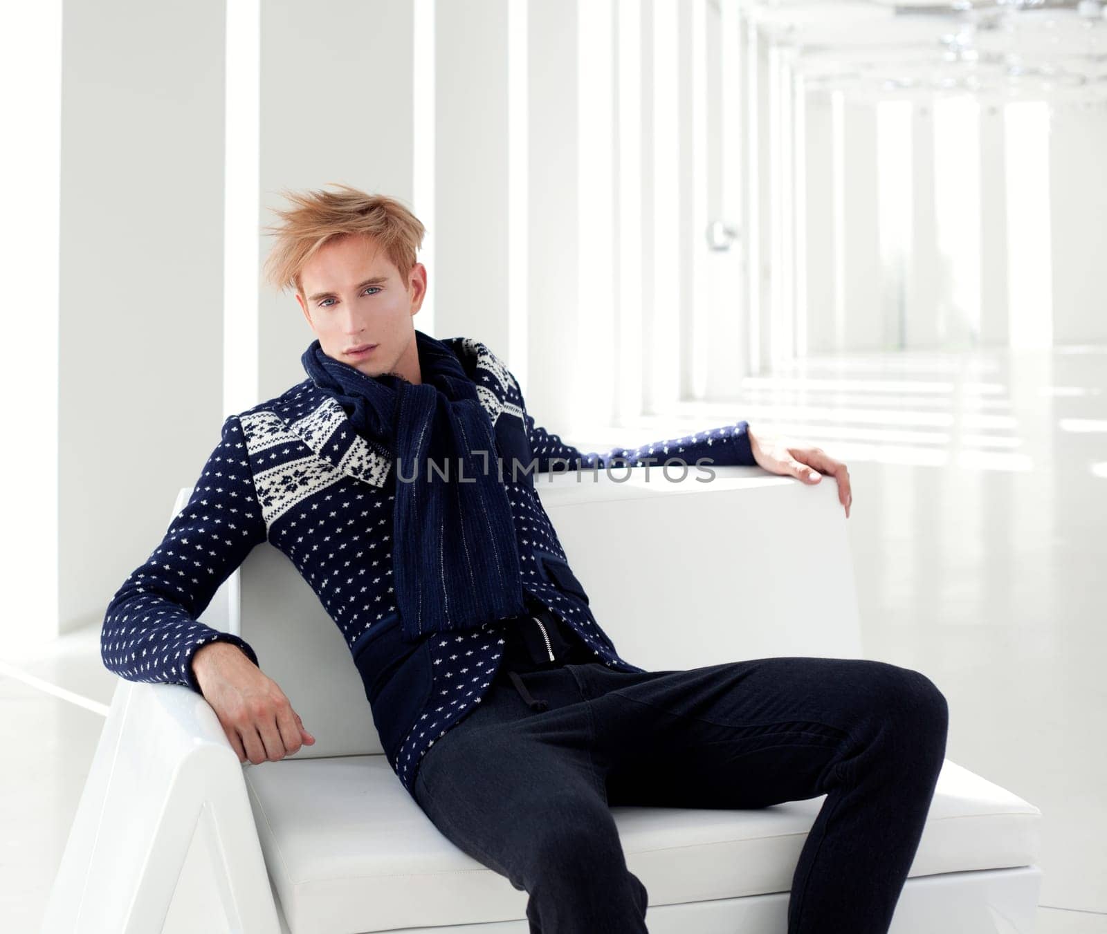 modern blond male futuristic sci-fi sitting in white indoor