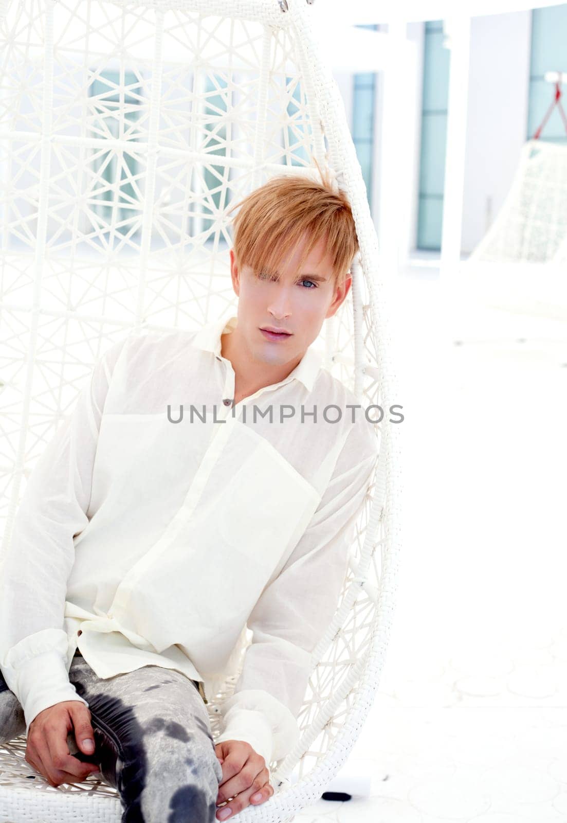 blond modern man portrait in summer terrace vampire inspiration
