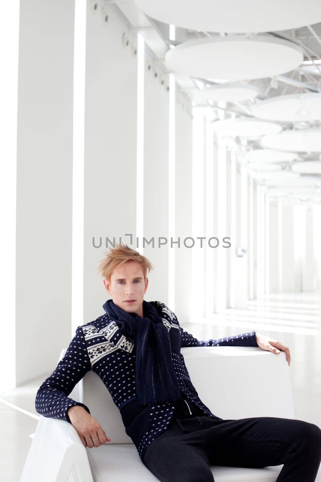 modern blond male futuristic sci-fi sitting in white indoor