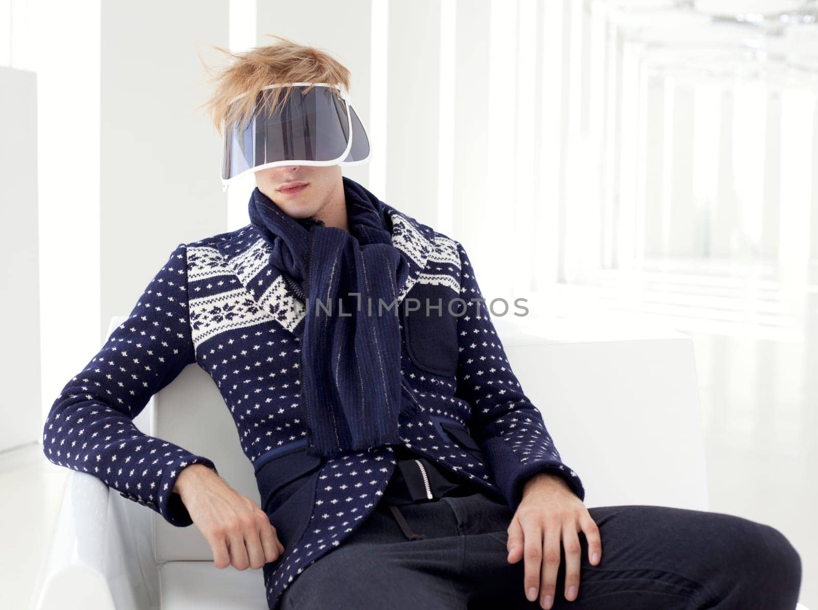 modern male model with futuristic sci-fi visor sitting in white indoor