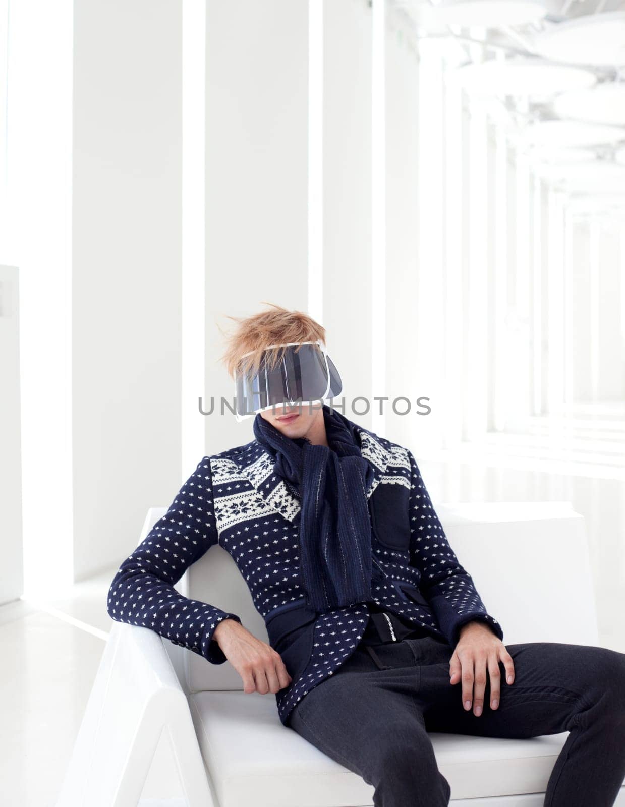 modern male model with futuristic sci-fi visor sitting in white indoor