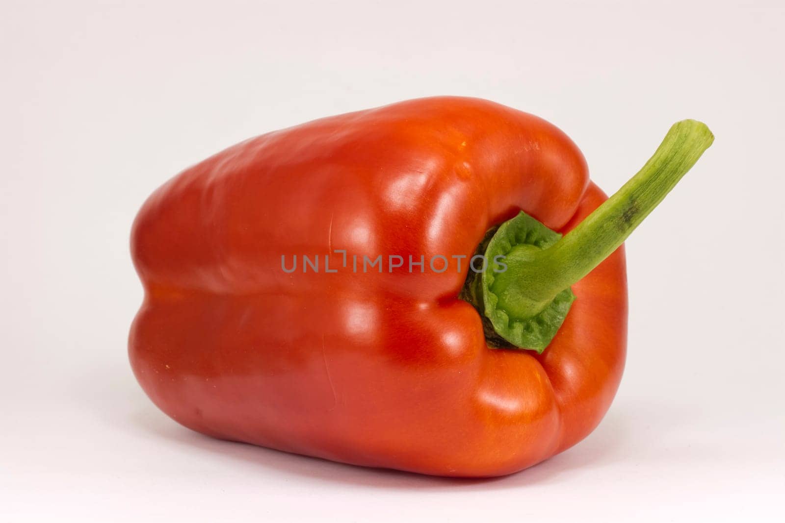 Bright red pepper isolated on white.