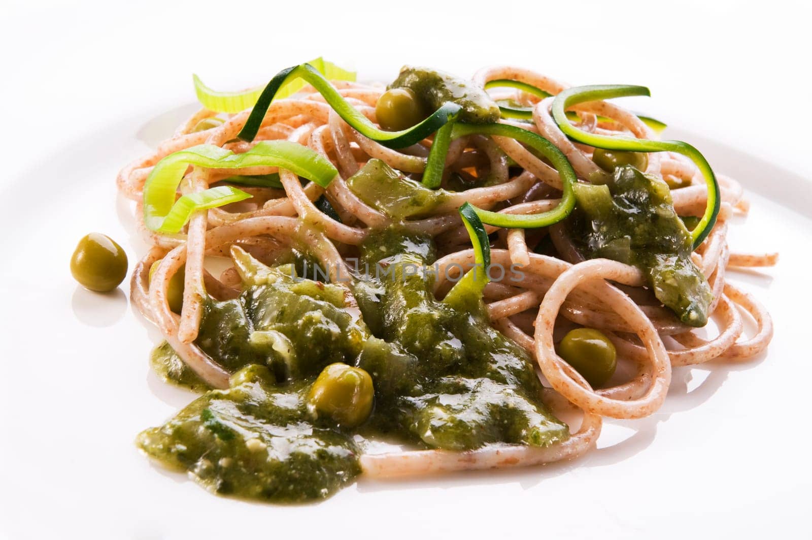 Whole grain spaghetti with vegetable sauce close up