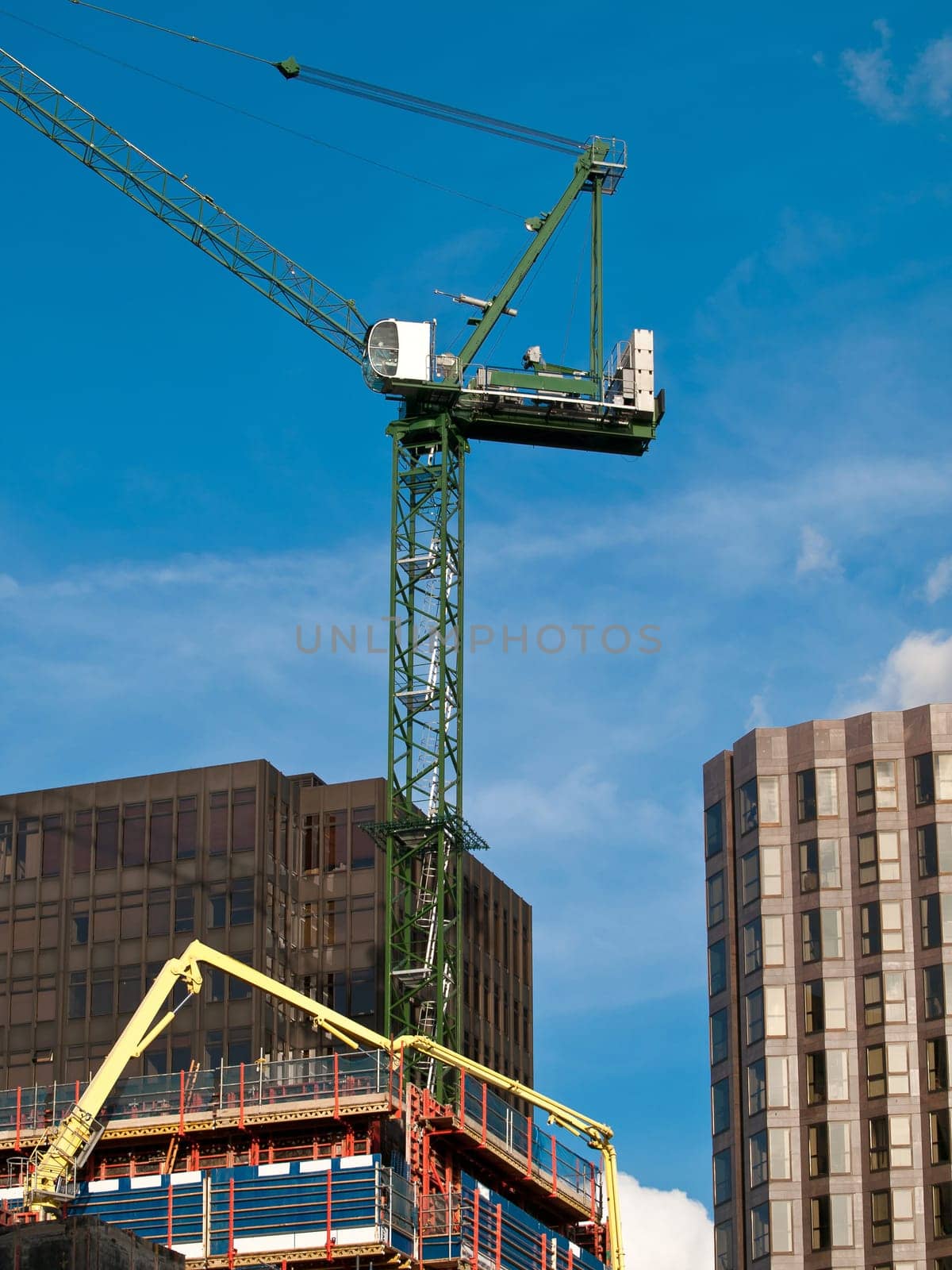 big high crane and skyscrapers on the street of London