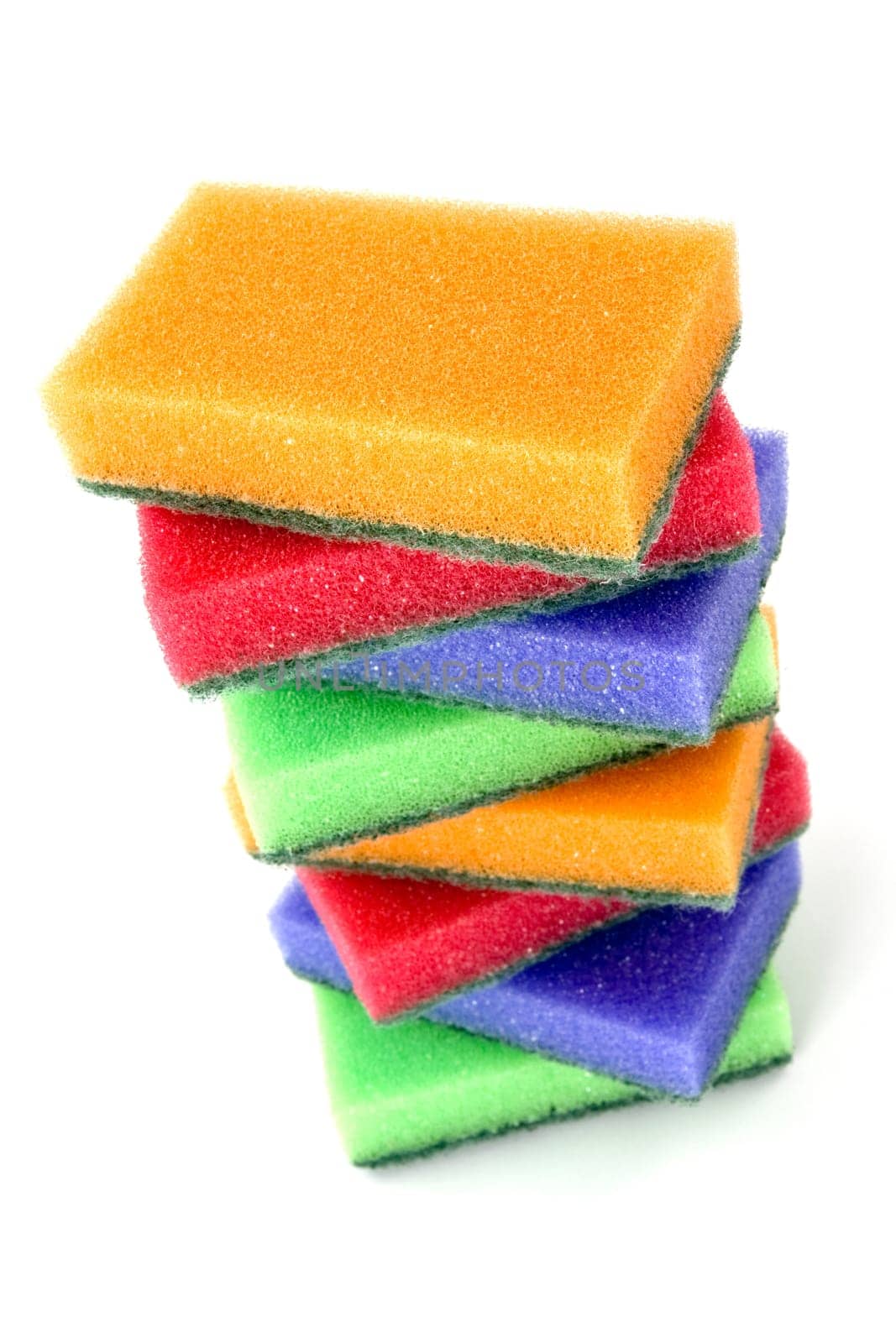 Brightly colored sponges on white background with copy space