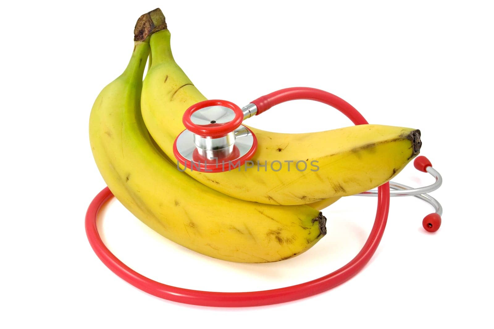 Bananas and Stethoscope over a white background