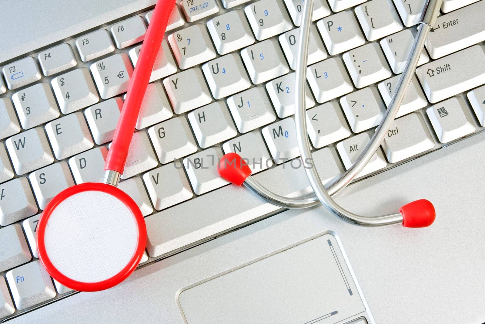 Concept for online medicine or IT support . Computer keyboard with a stethoscope.