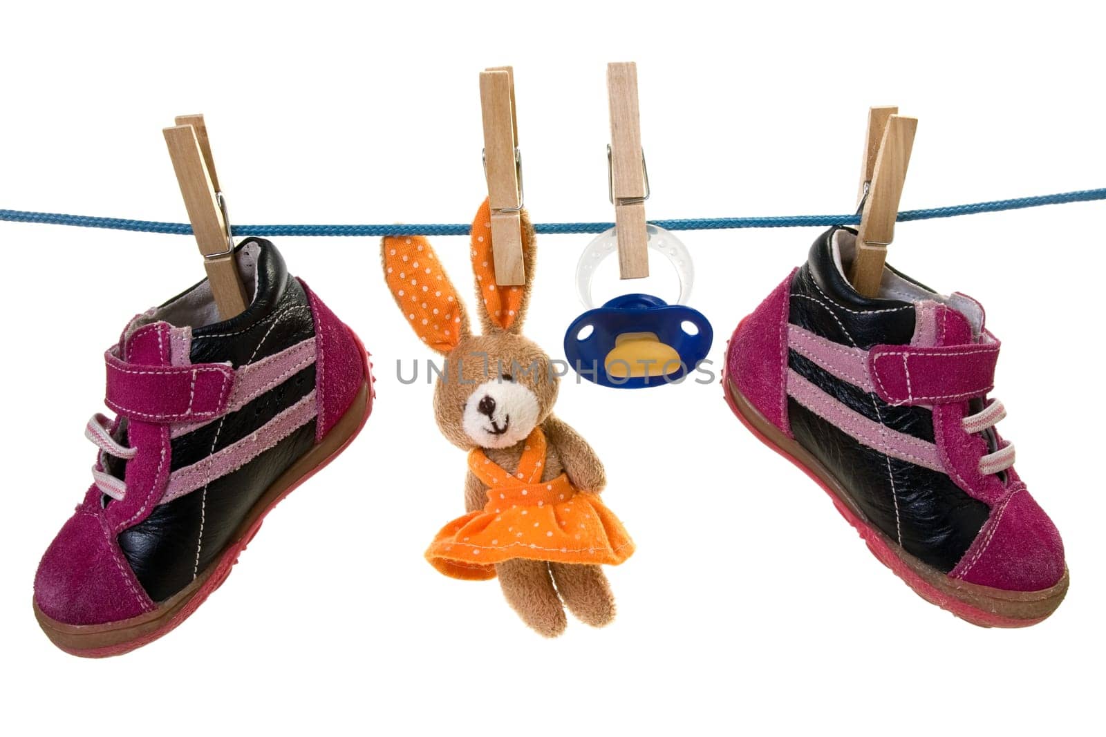 Blue pacifier ,toy and baby shoes hanging on a cord. isolated on white background