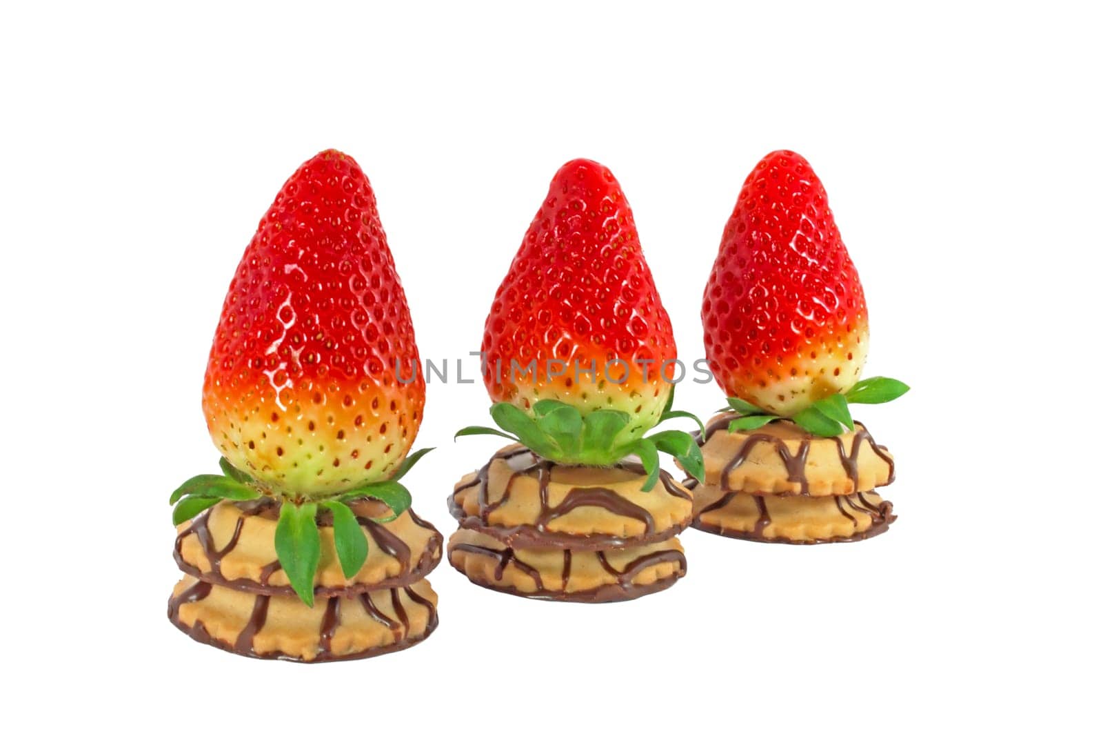 Three fresh ripe strawberry on a cakes in a row isolated on white background