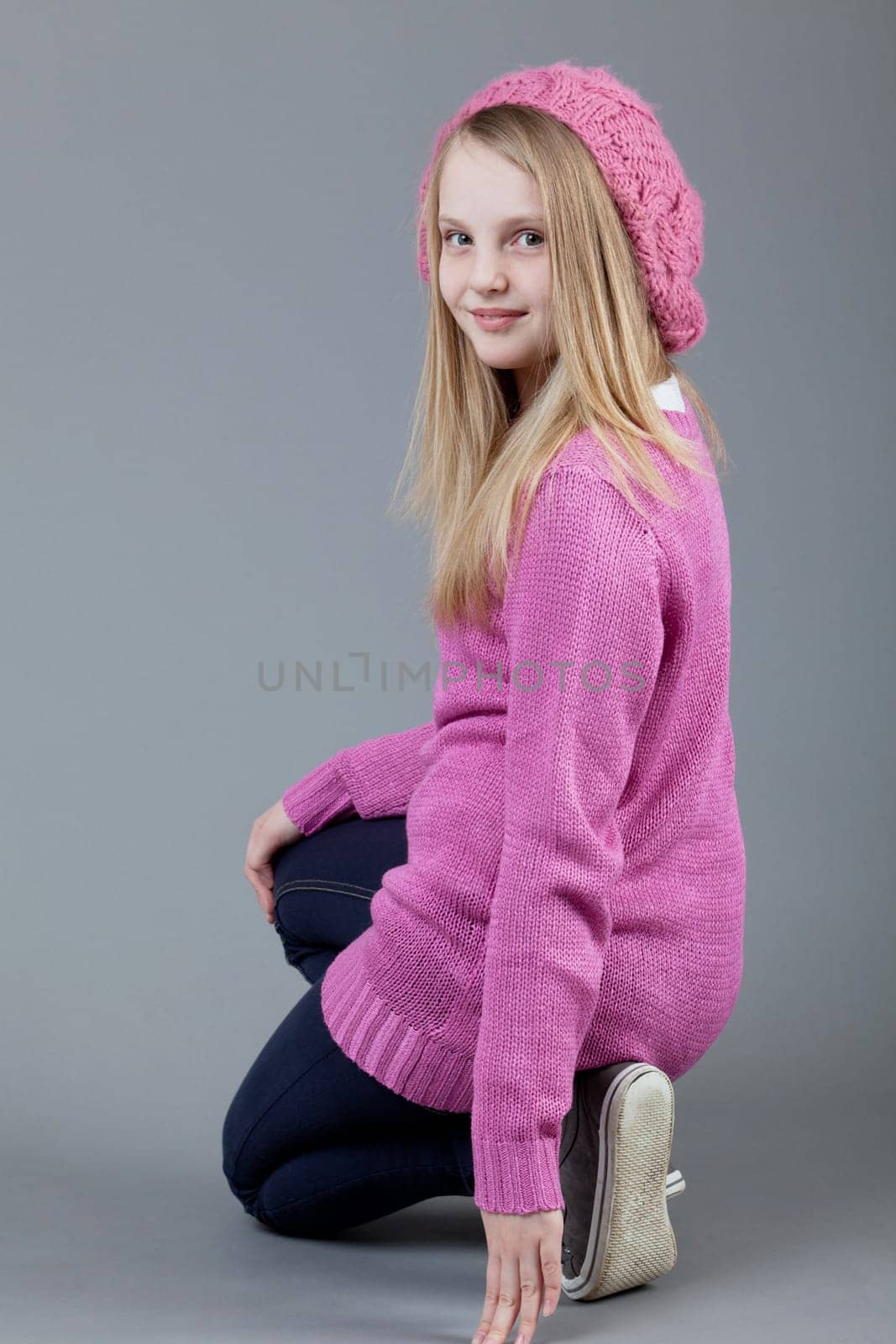 young happy girl.  little girl on a gray background